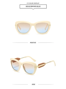 Detail of beige cat-eye sunglasses with thick frames and brown-blue gradient lenses