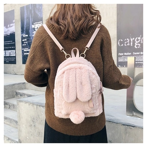 Rear view of a pink plush bunny backpack featuring cute long ears and a fluffy pom tail