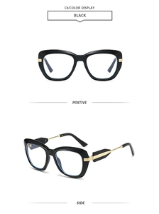 Detail view of black vintage polygonal frames with golden metal hinge accents