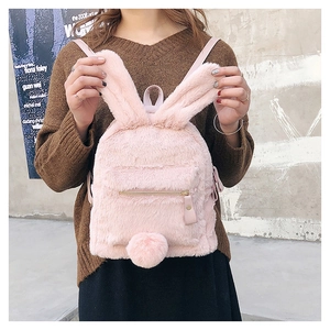 Detailed view of a pink plush bunny backpack with cute ears and a fuzzy pom-pom tail