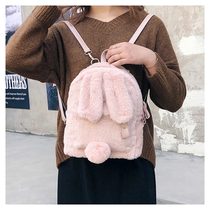 Detail of pink faux fur backpack featuring cute bunny ears and soft plush texture