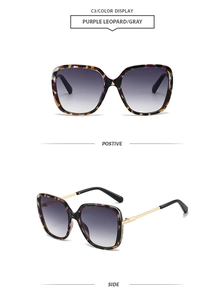 Detail view of purple leopard print oversized sunglasses with golden metal temples and gray lenses