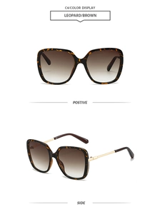Detail view of square tortoiseshell sunglasses with gold temples and brown gradient lenses