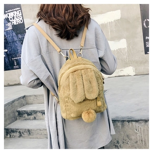 Detail view of plush bunny ear backpack with fuzzy tail and slim faux leather straps