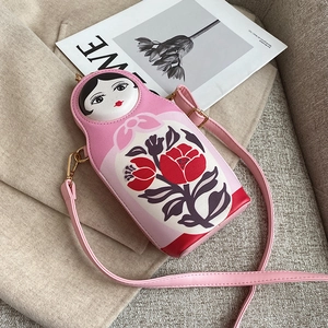 Pink Matryoshka PU crossbody bag with floral patterns on beige wool texture surface