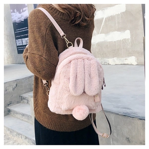 Detailed back view of pink plush rabbit backpack with cute long ears and fluffy pom tail