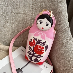 Close-up of pink Matryoshka doll PU leather crossbody bag with floral patterns
