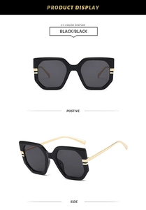 Front and side views of irregular oversized black sunglasses with gold metal temples