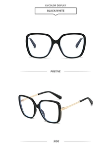 Detail view of large square black frame sunglasses with slim gold metal temples