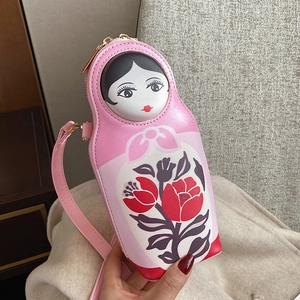 Detail of creative Russian doll PU crossbody bag in pink with floral patterns