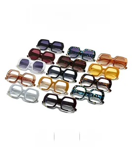 Flat lay of diverse stylish oversized square sunglasses in thirteen assorted colors