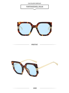 Front and side view of oversized tortoiseshell sunglasses with blue lenses and gold temples