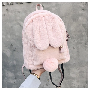 Detailed close-up of pink fluffy rabbit backpack showing soft fur and long ears