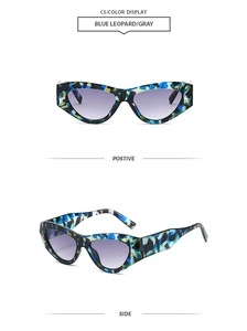 Detail view of cat eye sunglasses featuring blue leopard pattern and gray lenses