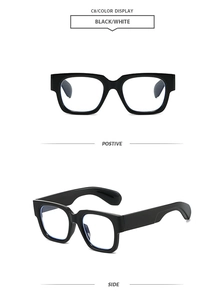 Detail view of square black and white sunglasses with thick frame and wide temples