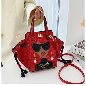Detail of red crocodile texture handbag with fashion lady patch and pearl earrings detail