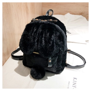 Detail of cute black faux fur mini backpack featuring long rabbit ears and fuzzy pompom tail