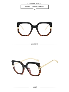 Detail of oversized black and leopard print frames with sleek gold metal temples