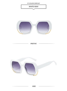 Detail showing white polygon frame sunglasses with golden metal trim and gradient lenses
