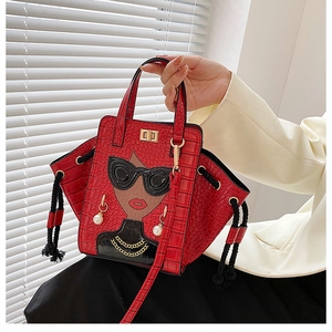 Detail of red crocodile texture handbag featuring cartoon female face with pearl earrings