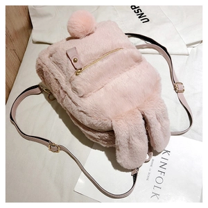 Detail of pink faux fur rabbit ear backpack with golden zipper and leather straps