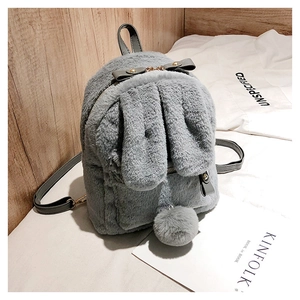 Detail of grey plush mini backpack with cute rabbit ears and fluffy faux fur pompom tail