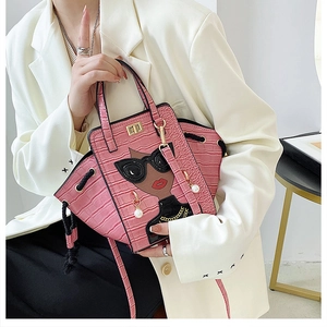 Detailed shot of pink crocodile pattern wing bag with cartoon fashion girl motif