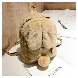 Detail of cute plush bunny ears and soft fur texture on a beige faux fur backpack