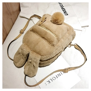 Detail of plush bunny ear backpack with golden zipper and adjustable leather strap