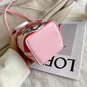 Detail view of pink PU leather bucket bag with abstract floral prints and fine stitching