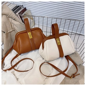 Detail of caramel and cream shell bags featuring lychee grain and metal clasps