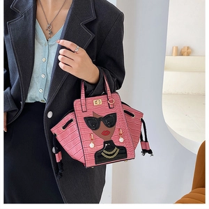 Pink faux leather bag with crocodile texture and stylish cartoon portrait embroidery detail