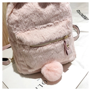 Detailed shot of pink plush backpack featuring fluffy rabbit ears and metal zipper detail