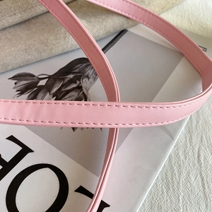 Detail of the light pink PU leather strap showing fine grain and even stitching accents