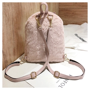 Detail of pink faux fur backpack with rabbit ears, soft texture and gold hardware