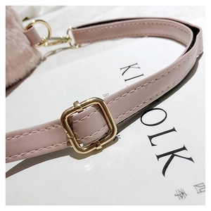Detail of adjustable faux fur and leather strap with gold metal buckle on pink backpack