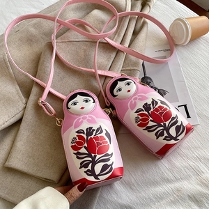 Detail of creative Matryoshka PU leather crossbody bag with rose patterns and gold hardware