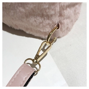 Close-up of pink faux fur texture with gold metal buckle and leather strap detail