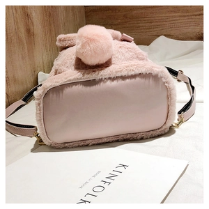Detailed bottom view of pink faux fur backpack with PU leather base and metal hardware