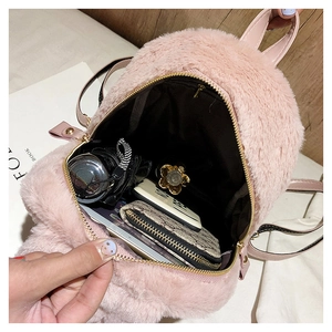 Internal view of the pink faux fur backpack showing ample space for a phone and wallet