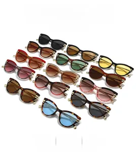 Collection of vintage cat-eye sunglasses in various colors with elegant gold metal hinges
