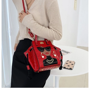 Detail of red crocodile texture handbag with chic lady embroidery and pearl accents