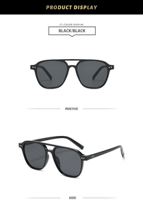 Close-up of black double-bridge aviator sunglasses with silver stud detail and dark lenses