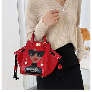 Detail of red croc-embossed wing bag featuring fashion lady illustration and pearl earrings