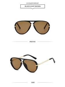 Detail view of aviator sunglasses with black double-bridge frame and light brown lenses