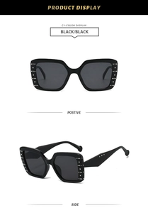 Detail view of black square frame sunglasses with silver rhinestones on front and side