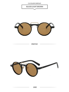 Detail of vintage round sunglasses with black frame, light brown lenses and gold bridge