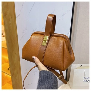 Brown litchi grain leather shell bag with golden twist lock and wide handle detail
