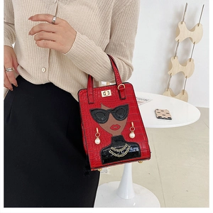 Detail of red crocodile texture handbag featuring fashion portrait and gold lock clasp