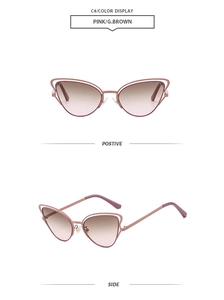 Detail of pink cat eye sunglasses with hollow metal frames and gradient brown lenses